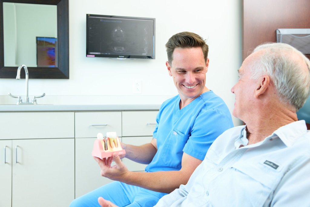 Dentist sitting beside a patient