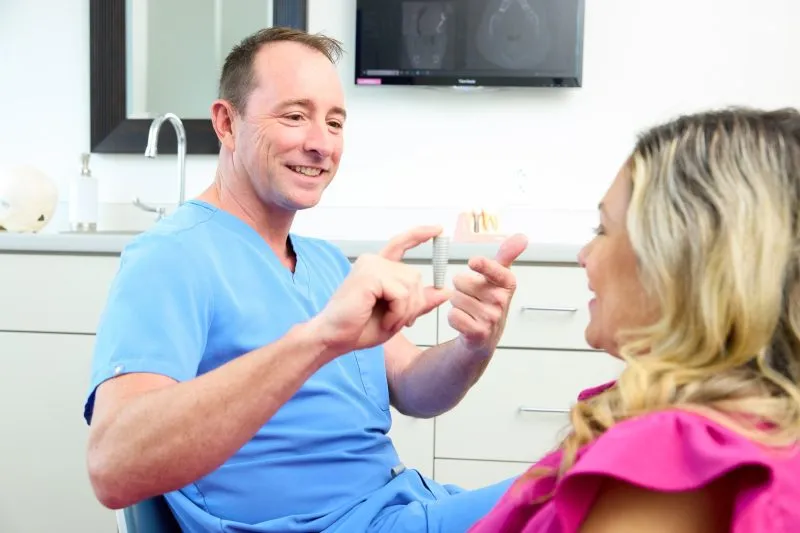 Dr. Daniel Harris discussing dental implants with a patient